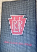  Former PRR style LIRR herald on the rug inside the Mineola Station building 